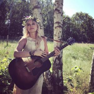 Sofia Talvik Sofia Talvik with flower wreath and a guitar